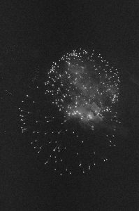 Breathtaking grayscale fireworks illuminating the night sky in a dramatic display.