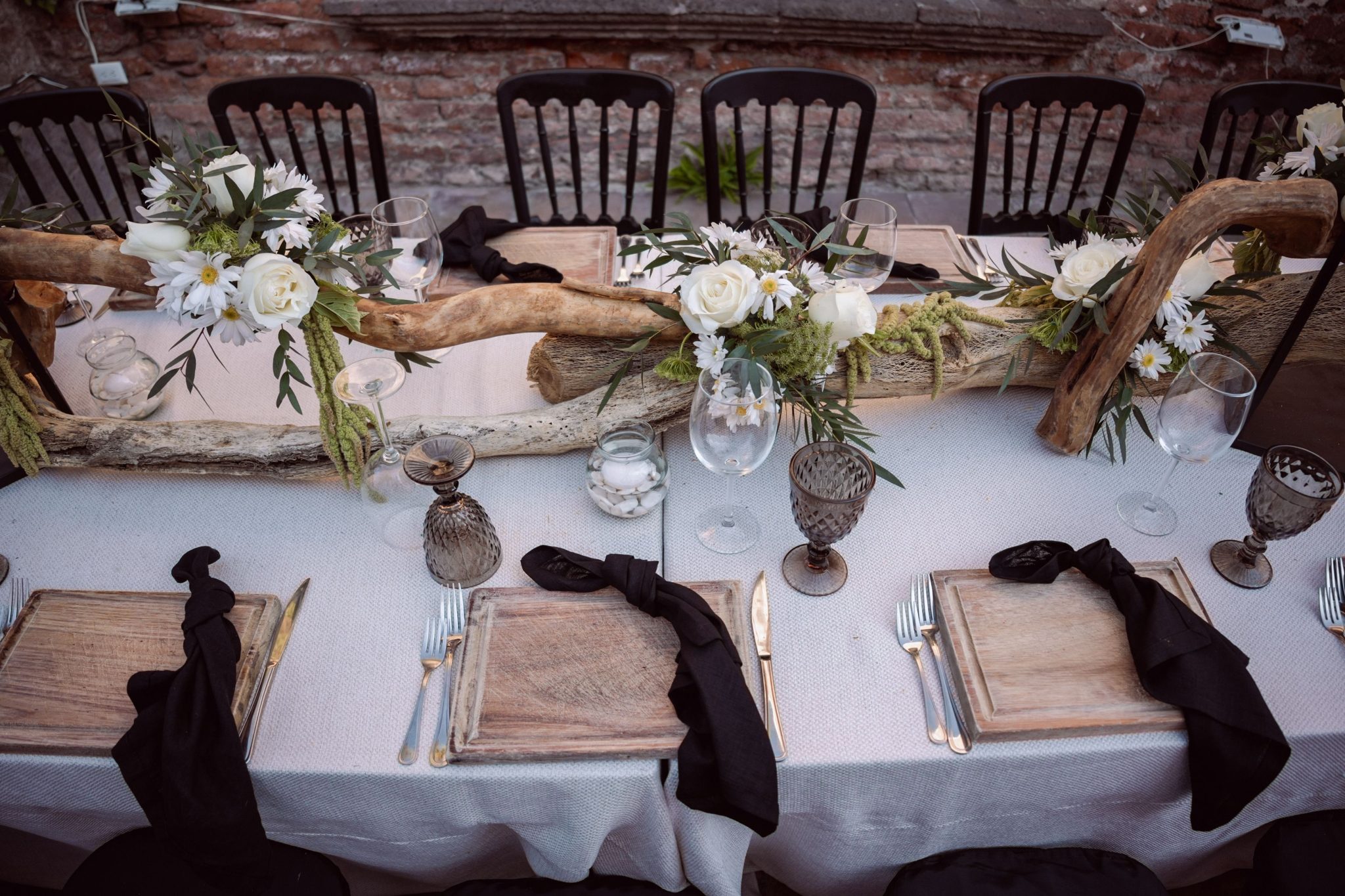 Beautifully decorated rustic wedding table setup with floral and wooden elements.